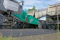 A modern road paver builds in asphalt and is loaded by truck Royalty Free Stock Photo